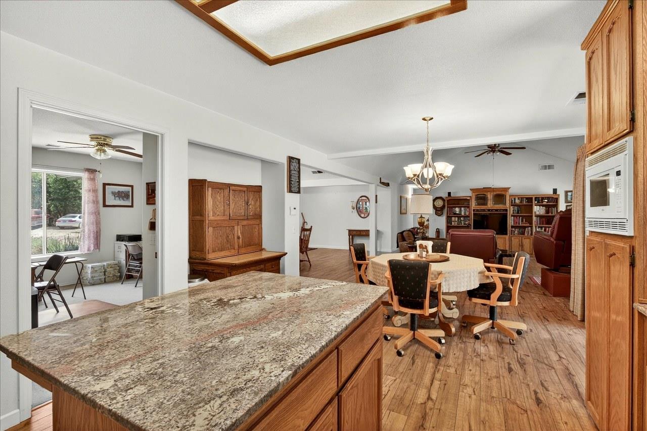 38090 Wortham Road Oakhurst, CA 93644 - Photo 16 of 54 a living room with dining room and wooden floor
