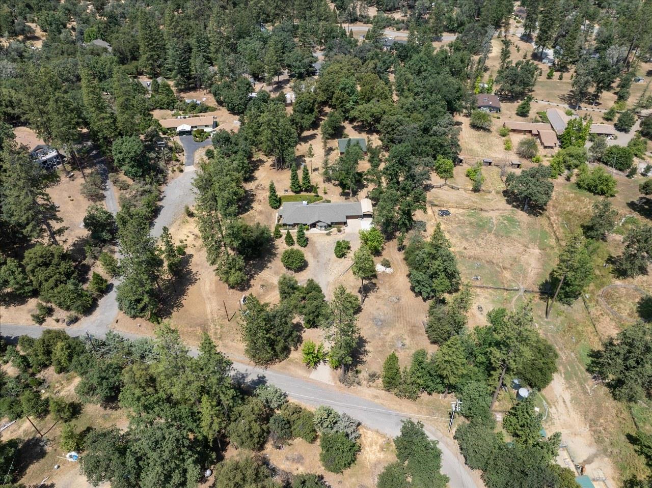 38090 Wortham Road Oakhurst, CA 93644 - Photo 2 of 54 an aerial view of residential houses with outdoor space