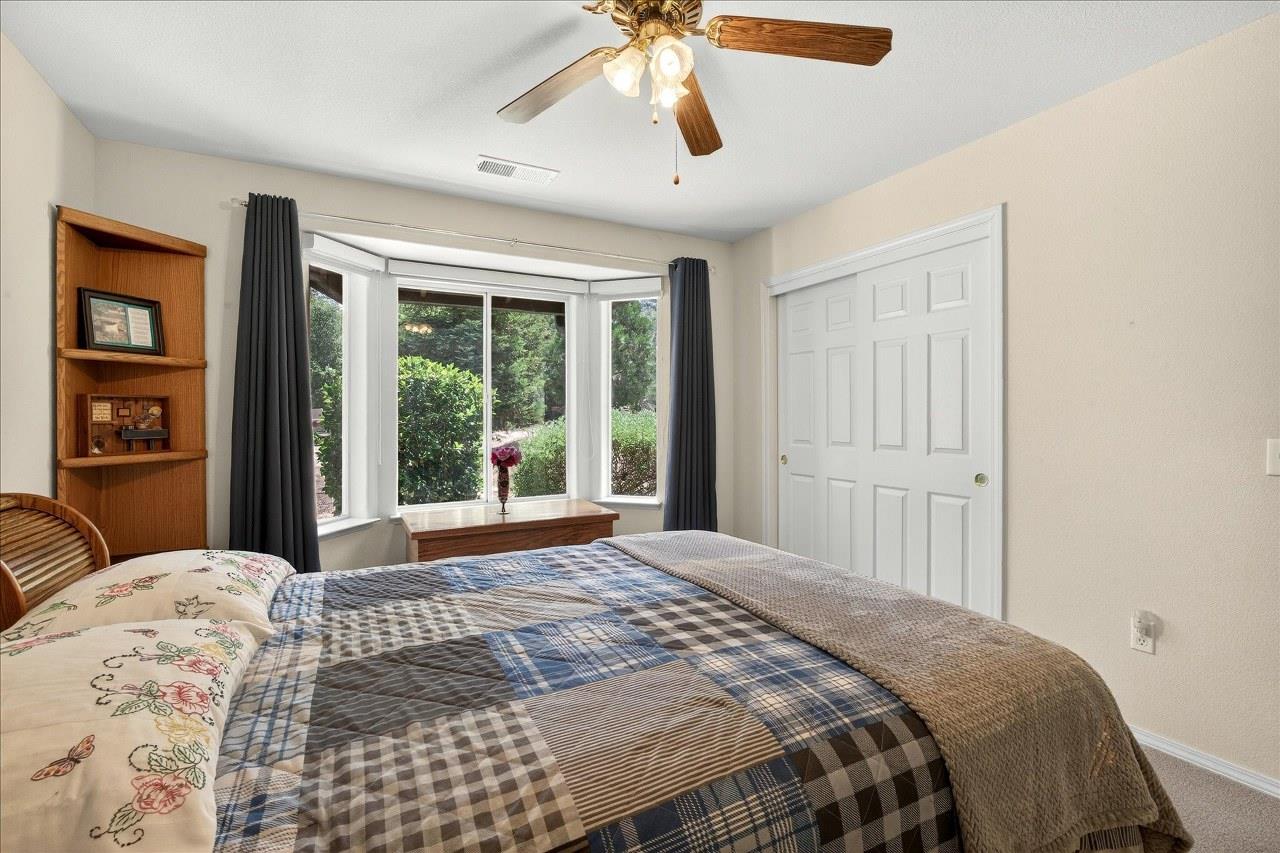 38090 Wortham Road Oakhurst, CA 93644 - Photo 24 of 54 a bedroom with a large bed and a window
