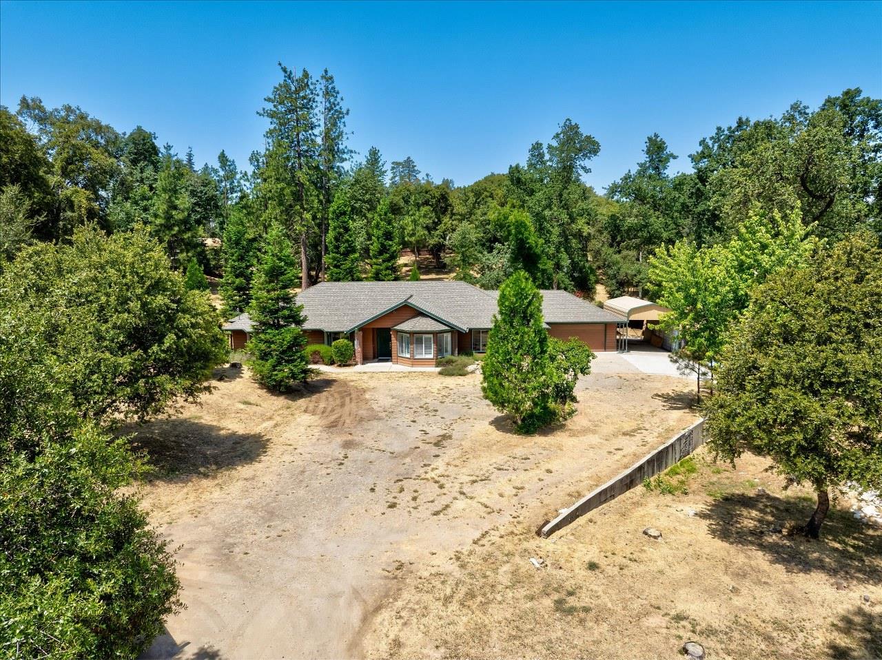 38090 Wortham Road Oakhurst, CA 93644 - Photo 4 of 54 a view of a house with a yard