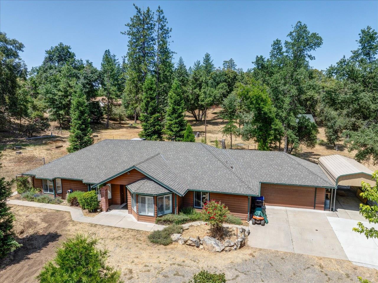 38090 Wortham Road Oakhurst, CA 93644 - Photo 5 of 54 an aerial view of a house with a yard