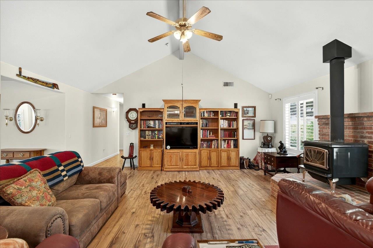 38090 Wortham Road Oakhurst, CA 93644 - Photo 7 of 54 a living room with furniture a chandelier and a flat screen tv