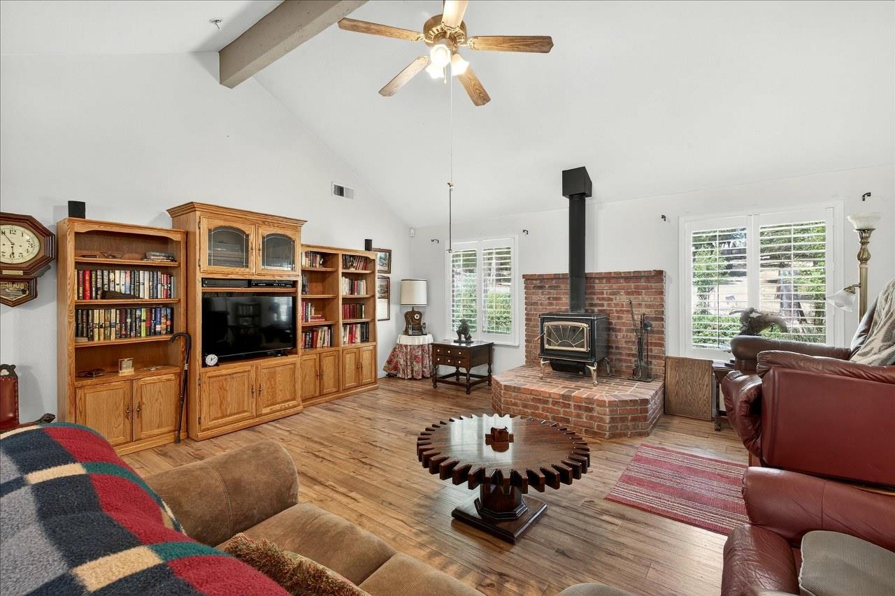 38090 Wortham Road Oakhurst, CA 93644 - Photo 9 of 54 a living room with furniture fireplace and flat screen tv
