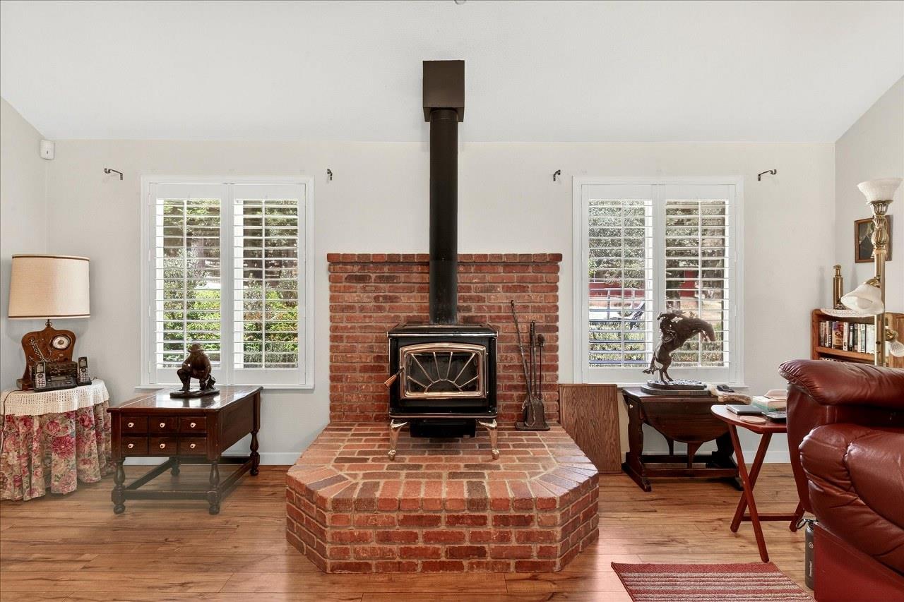 38090 Wortham Road Oakhurst, CA 93644 - Photo 10 of 54 a living room with furniture a large window and a fireplace