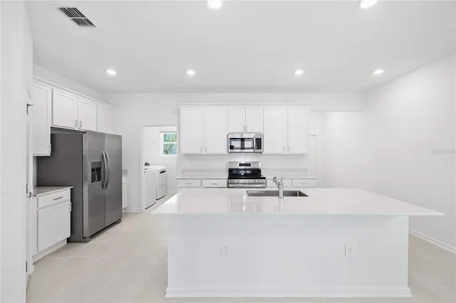 a kitchen with stainless steel appliances a refrigerator and a stove