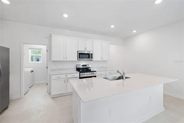 a kitchen with a sink a stove and cabinets