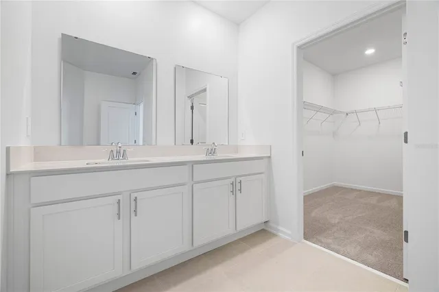 a bathroom with double sink and a mirror