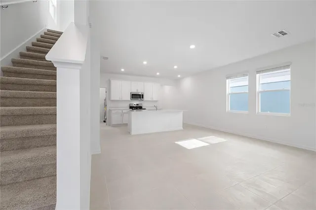 a view of a kitchen with furniture and a window