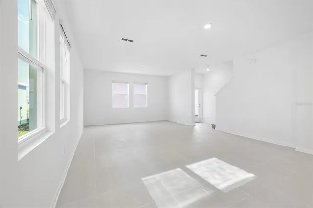 an empty room with windows and entrance