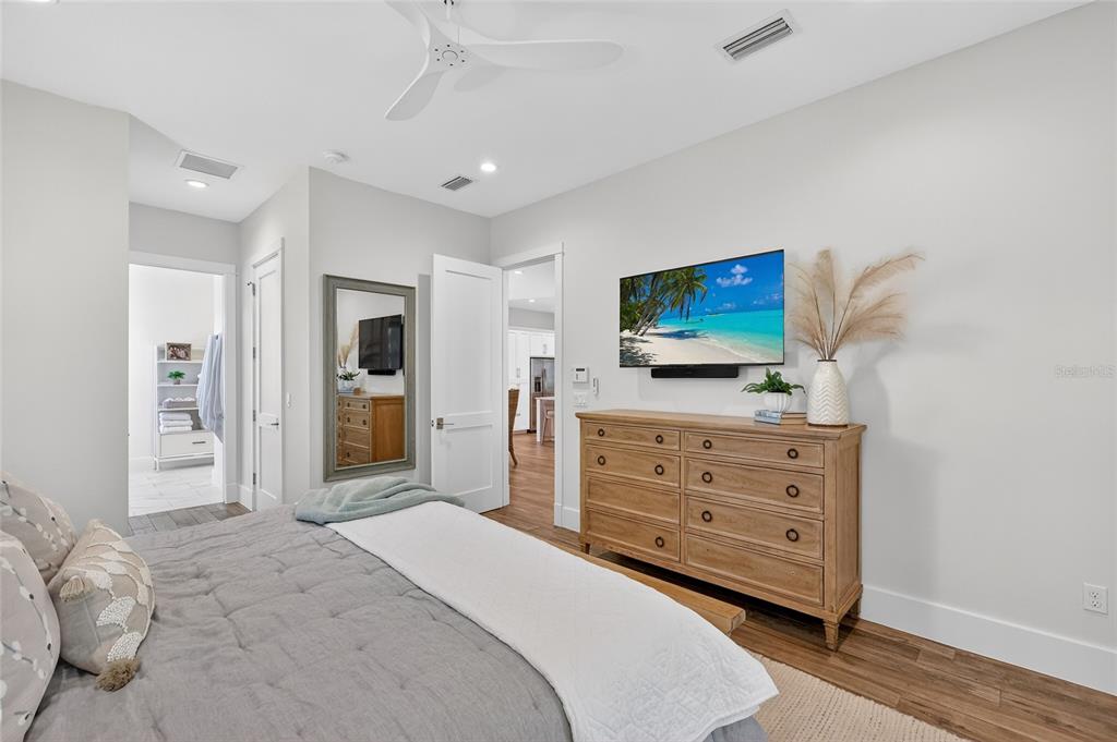 261 Seabreeze Court Boca Grande, FL 33921 - Photo 15 of 44 a bedroom with a bed and a flat screen tv in white walls