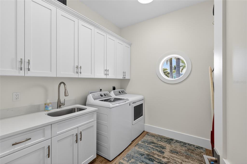 261 Seabreeze Court Boca Grande, FL 33921 - Photo 21 of 44 a view of a storage and utility room with washer and dryer