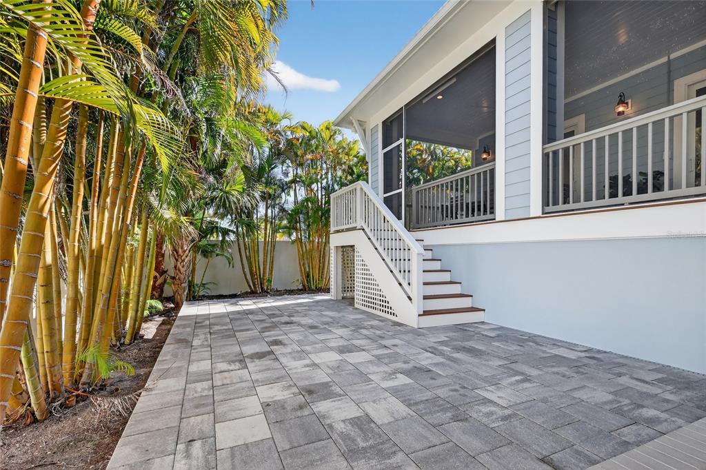 261 Seabreeze Court Boca Grande, FL 33921 - Photo 36 of 44 a view of a patio with a table and chairs and wooden floor