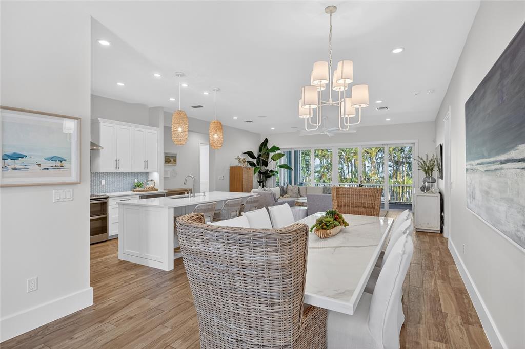 261 Seabreeze Court Boca Grande, FL 33921 - Photo 6 of 44 a living room with kitchen island furniture and a chandelier