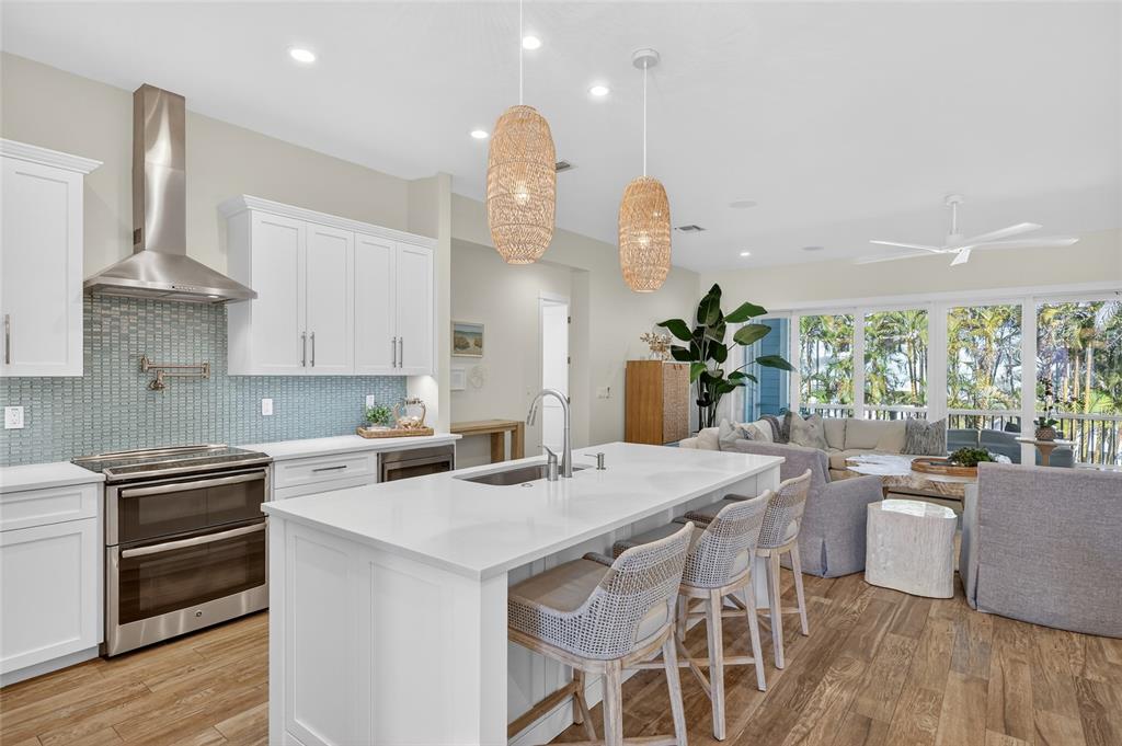 261 Seabreeze Court Boca Grande, FL 33921 - Photo 7 of 44 a kitchen with a table chairs stove and cabinets