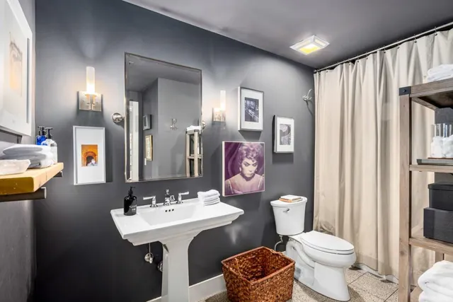 a bathroom with a sink mirror and toilet