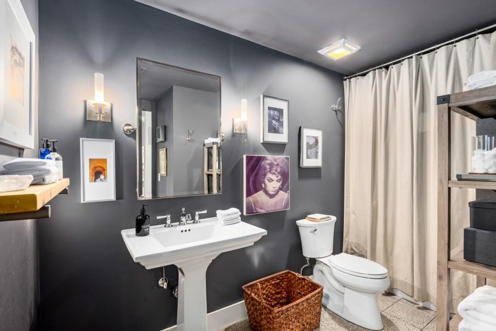 1100 Howell Mill Road Northwest, Unit 201 Atlanta, GA 30318 - Photo 16 of 50 a bathroom with a toilet sink and mirror