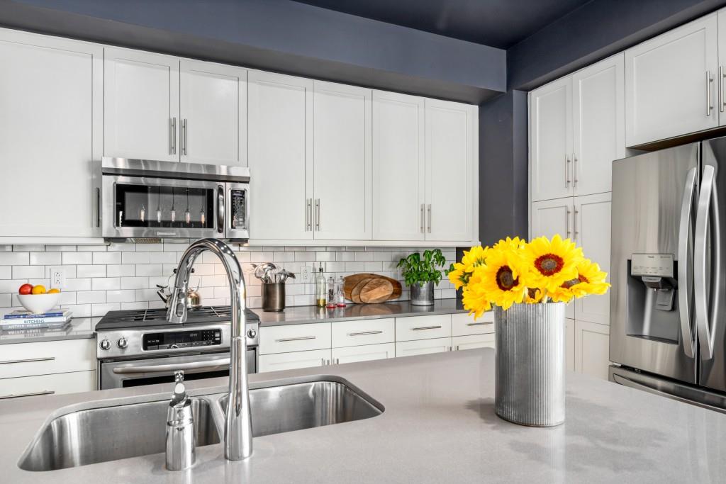 1100 Howell Mill Road Northwest, Unit 201 Atlanta, GA 30318 - Photo 2 of 50 a kitchen with stainless steel appliances a sink a stove a refrigerator a counter space and cabinets