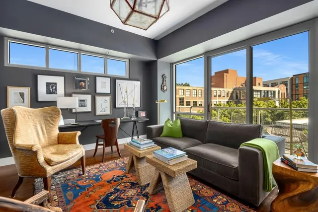 a living room with furniture and a floor to ceiling window