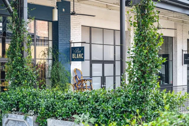 a view of a brick building with a sign broad