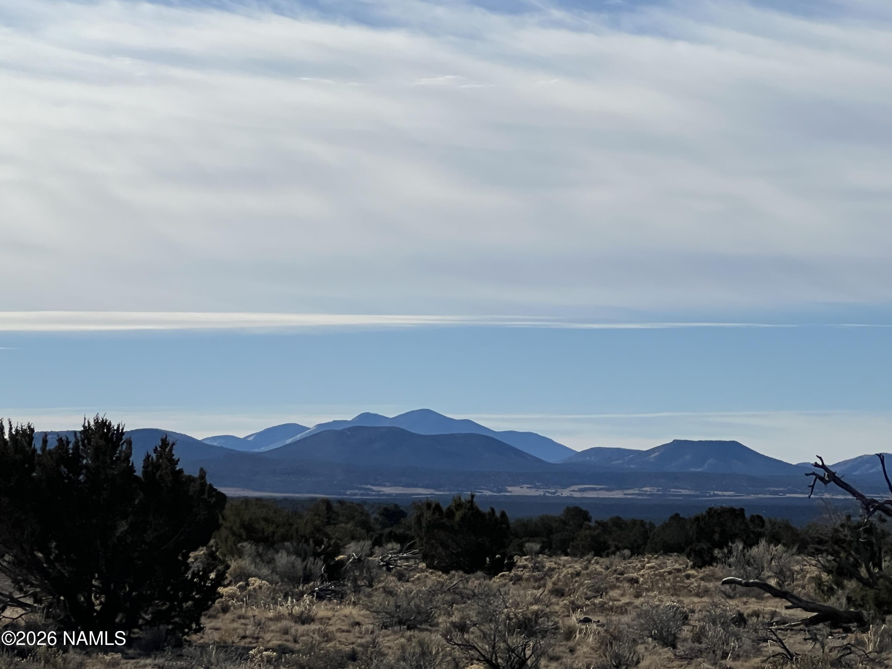 7211 East Roper Circle Williams, AZ 86046 - Photo 13 of 26 a view of a lush green hillside and a houses