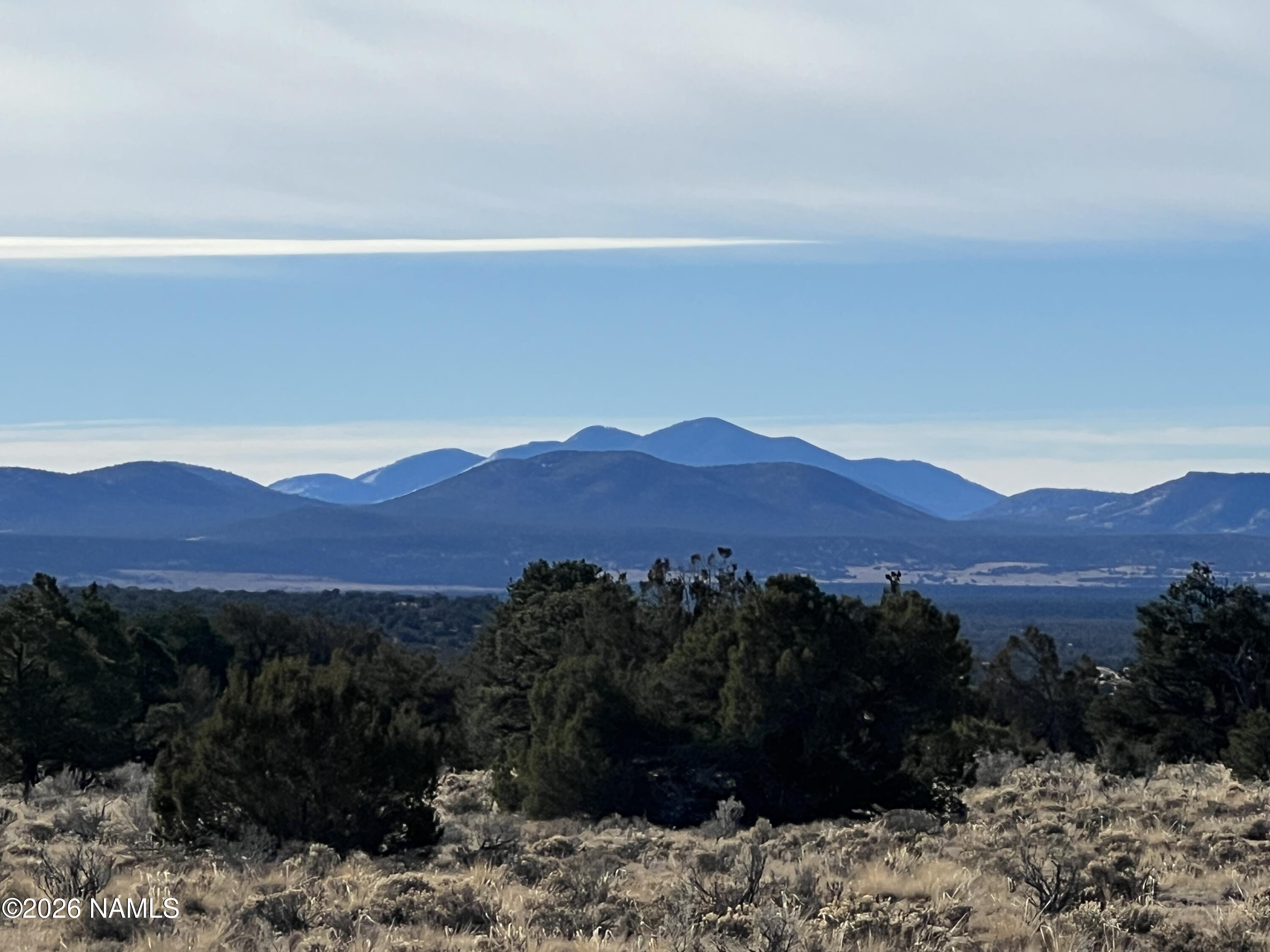 7211 East Roper Circle Williams, AZ 86046 - Photo 17 of 26 a view of a yard with a mountain