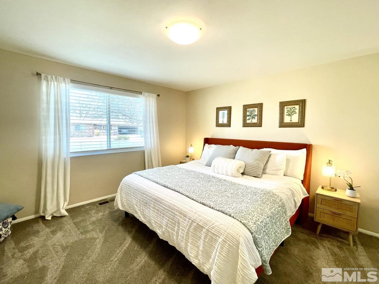 4001 Warren Way Reno, NV 89509 - Photo 12 of 28 a bedroom with a bed and wooden floor