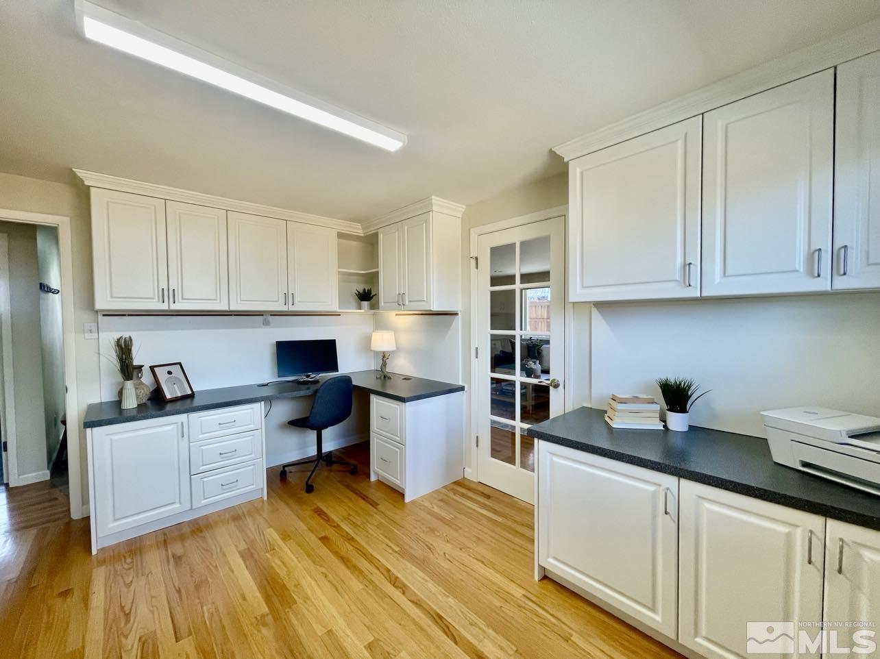 4001 Warren Way Reno, NV 89509 - Photo 20 of 28 a kitchen with sink cabinets and wooden floor