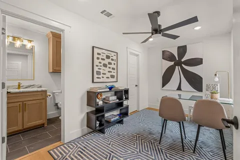a living room with furniture a rug and a chandelier