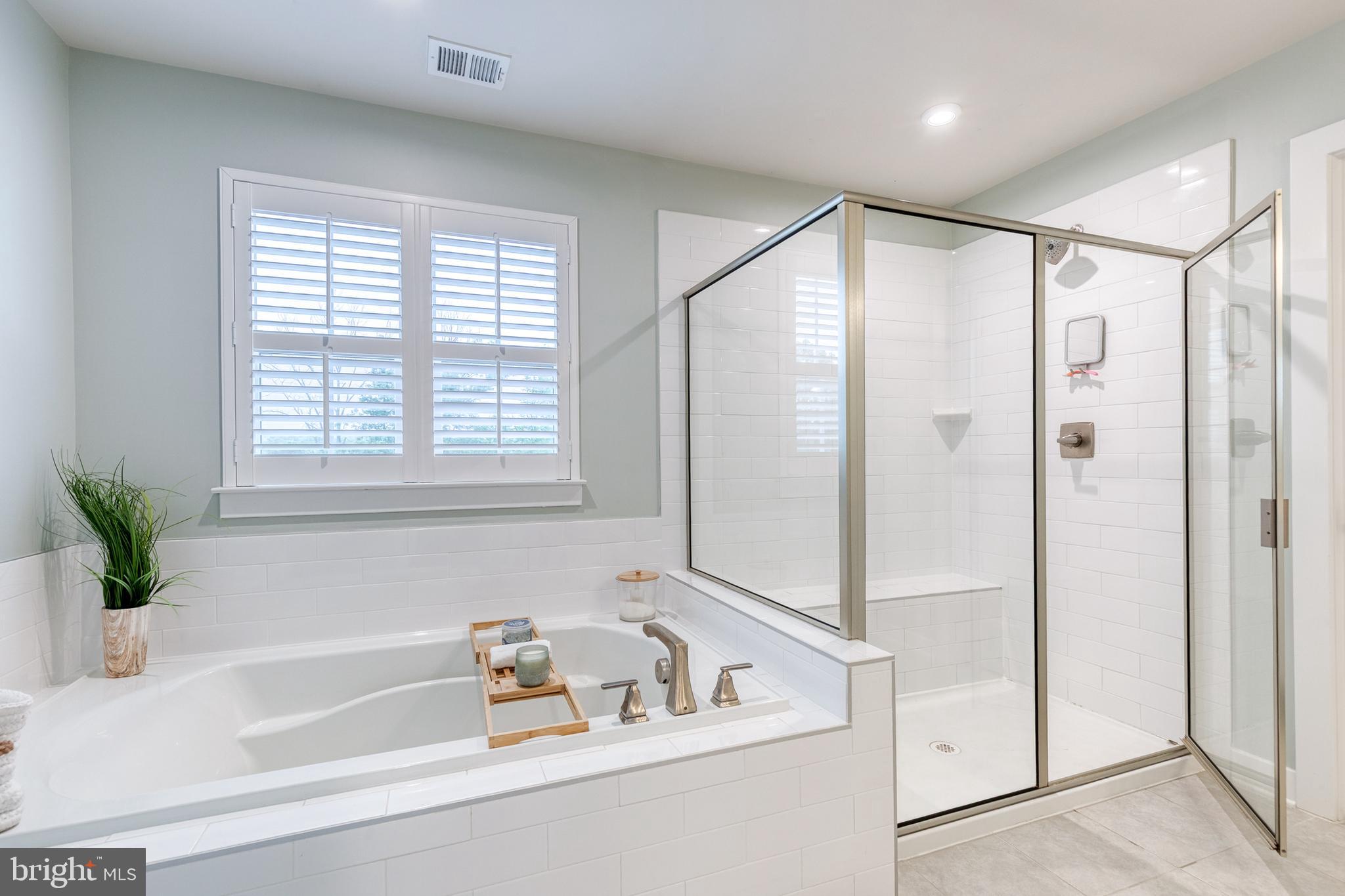 6003 Valentine Way Hanover, MD 21076 - Photo 37 of 52 a bathroom with a tub shower and window