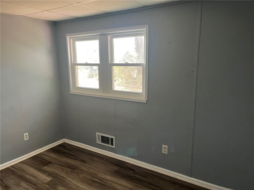3836 Rex Circle Rex, GA 30273 - Photo 12 of 17 a view of an empty room with wooden floor and a window