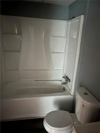 a bathroom with a toilet and a bathtub