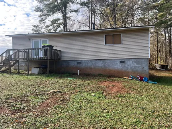 a backyard of a house with wooden fence and deck