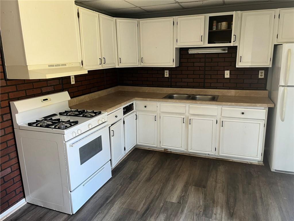 3836 Rex Circle Rex, GA 30273 - Photo 7 of 17 a kitchen with granite countertop white cabinets and white appliances