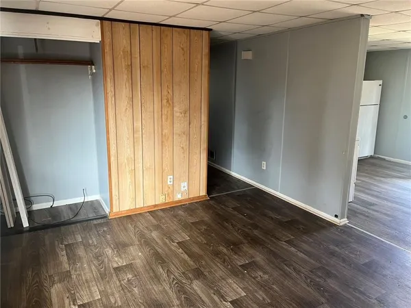 an empty room with wooden floor and closet