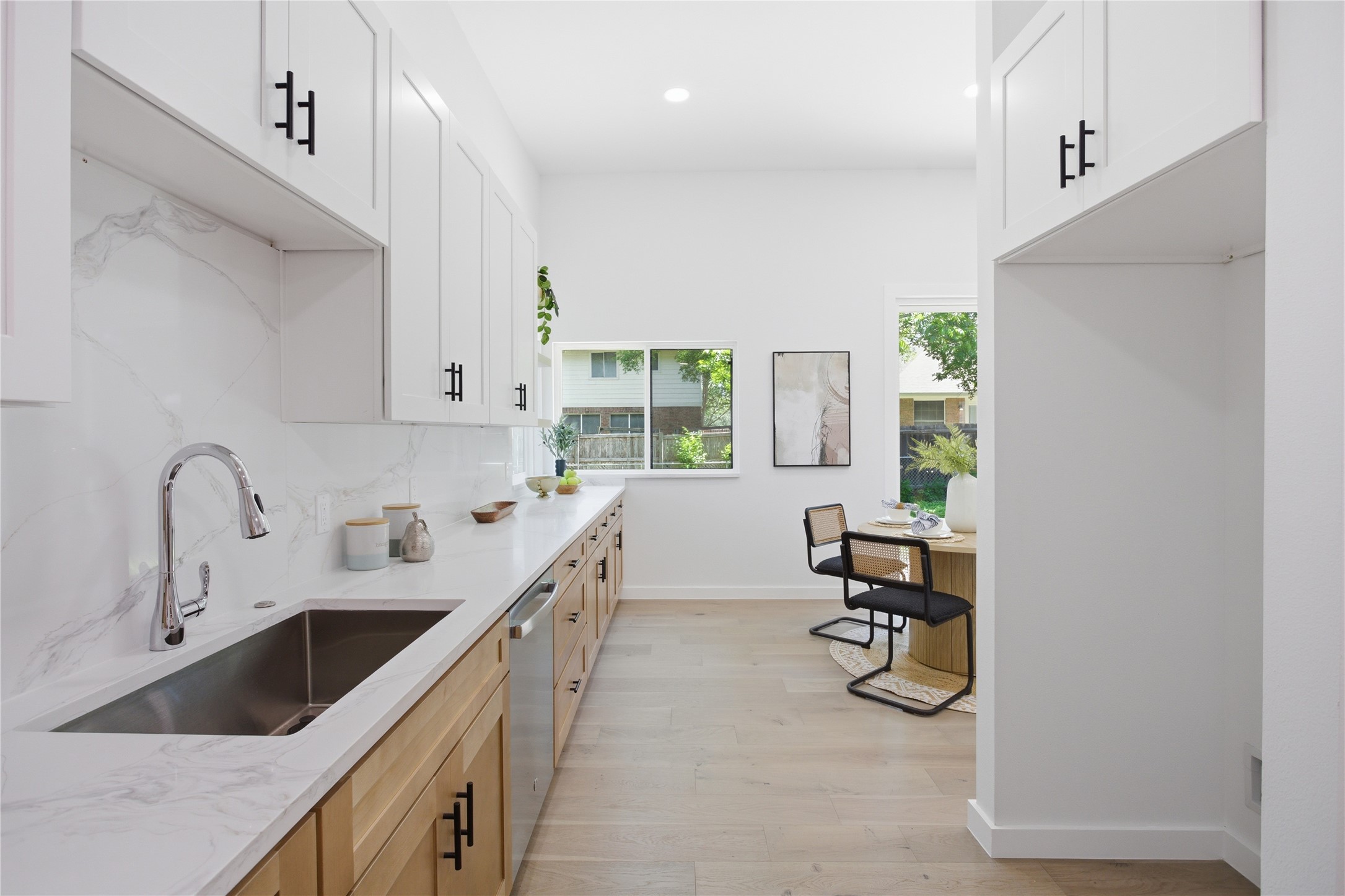 2110 Magazine Street Austin, TX 78727 - Photo 15 of 31 Contemporary kitchen featuring white upper cabinetry and light wood-finish lower cabinetry