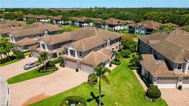 an aerial view of a house with garden space and street view