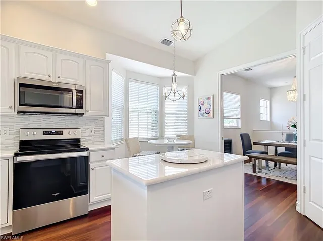 a view of kitchen with sink microwave and stove