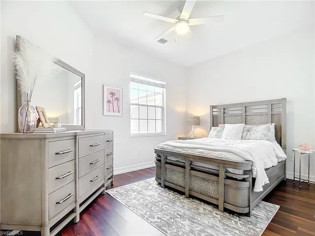 a bedroom with a bed and a dresser
