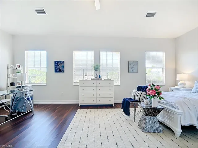 a bedroom with furniture and a wooden floor