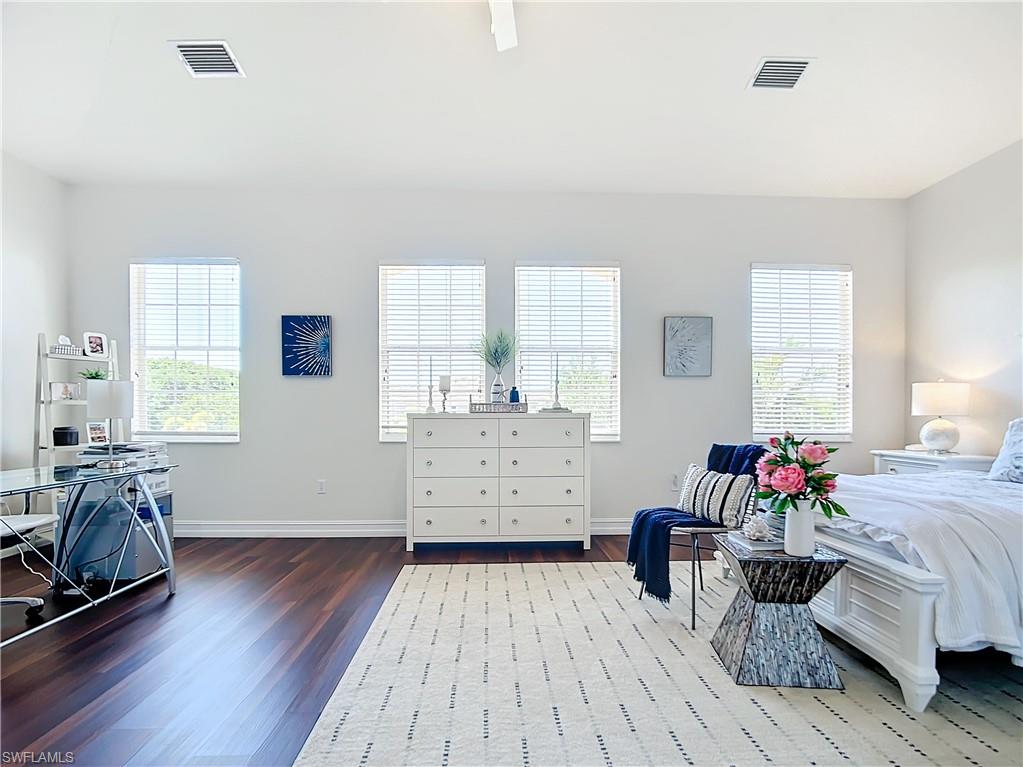 4752 Stratford Court, Unit 1404 Naples, FL 34105 - Photo 21 of 34 a bedroom with furniture and a wooden floor
