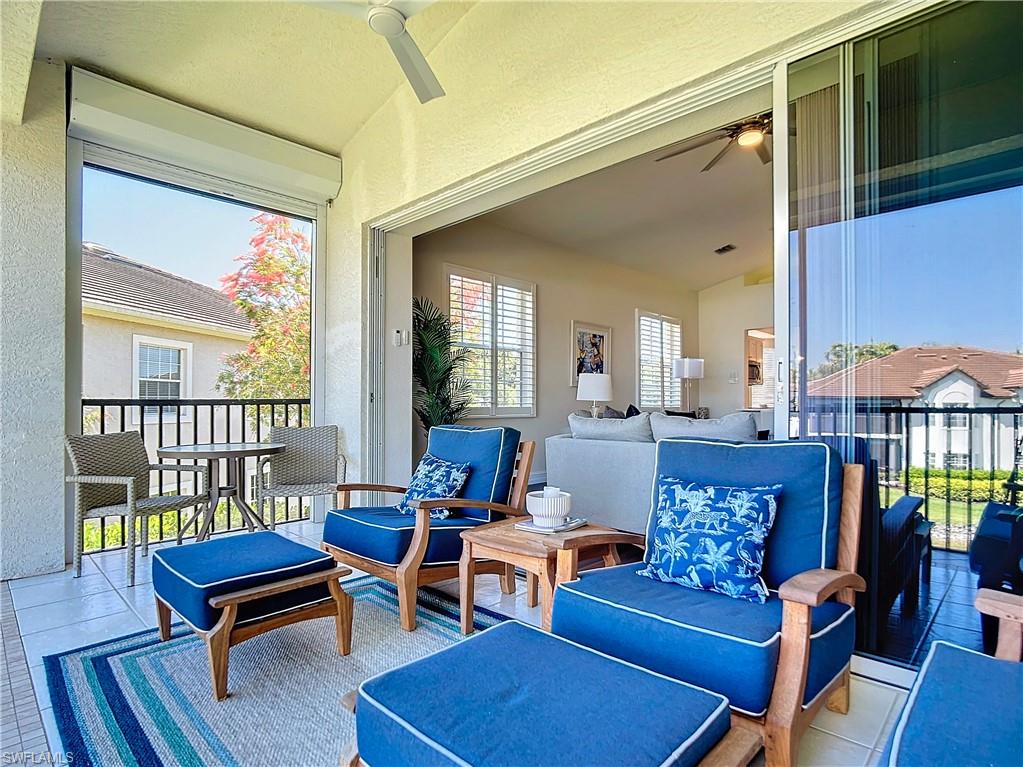 4752 Stratford Court, Unit 1404 Naples, FL 34105 - Photo 33 of 34 a living room with furniture a rug and a potted plant