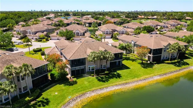 an aerial view of residential houses with yard