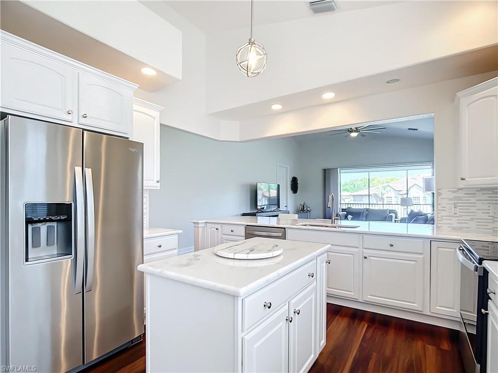 4752 Stratford Court, Unit 1404 Naples, FL 34105 - Photo 10 of 34 a kitchen with a sink stove and refrigerator