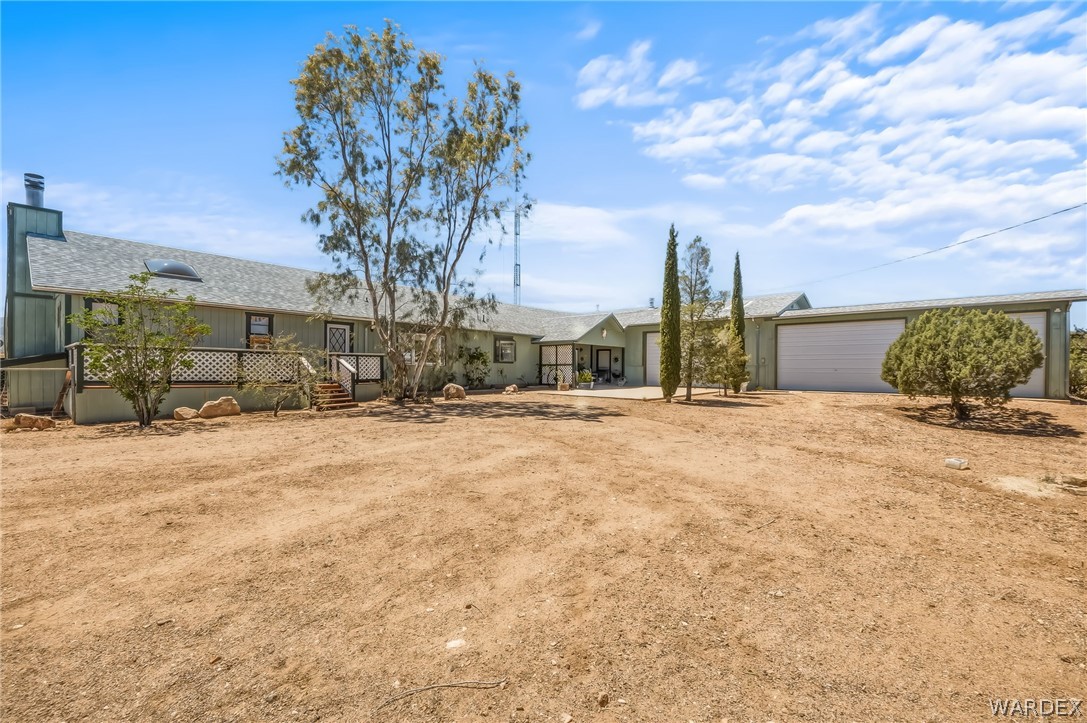 2401 North Stephan Road Kingman, AZ 86401 - Photo 80 of 92 Expansive property featuring a multi-car garage, pitched roofline, and elevated outdoor deck