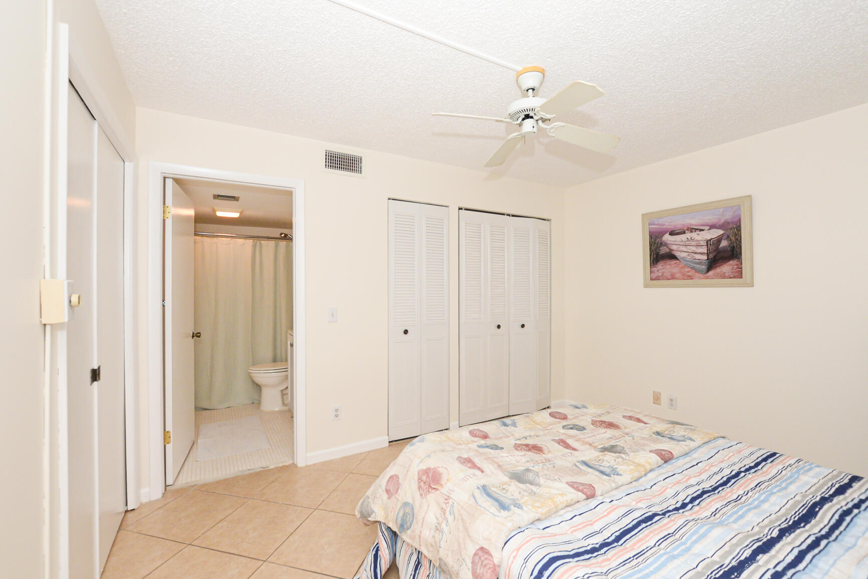 1950 Southwest Palm City Road, Unit 12103 Stuart, FL 34994 - Photo 13 of 37 a bedroom with a bed and a view of bathroom