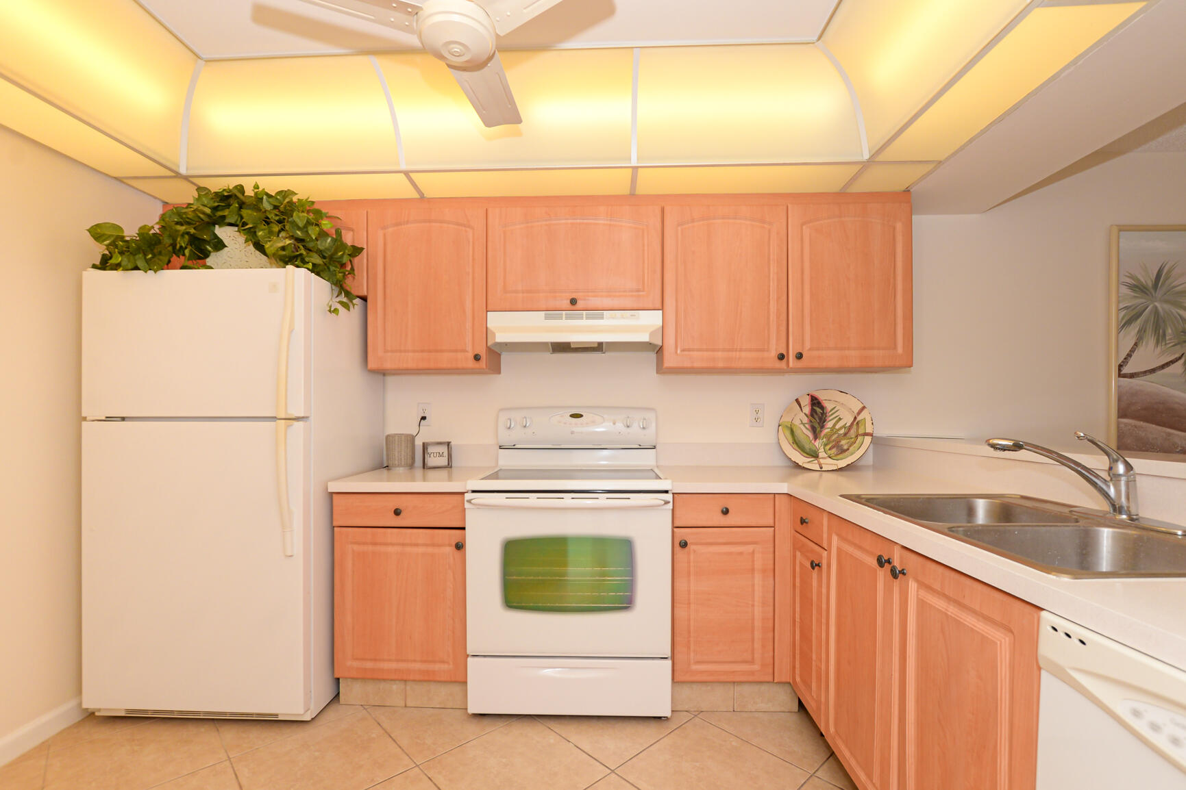 1950 Southwest Palm City Road, Unit 12103 Stuart, FL 34994 - Photo 6 of 37 a kitchen with a sink stove and refrigerator