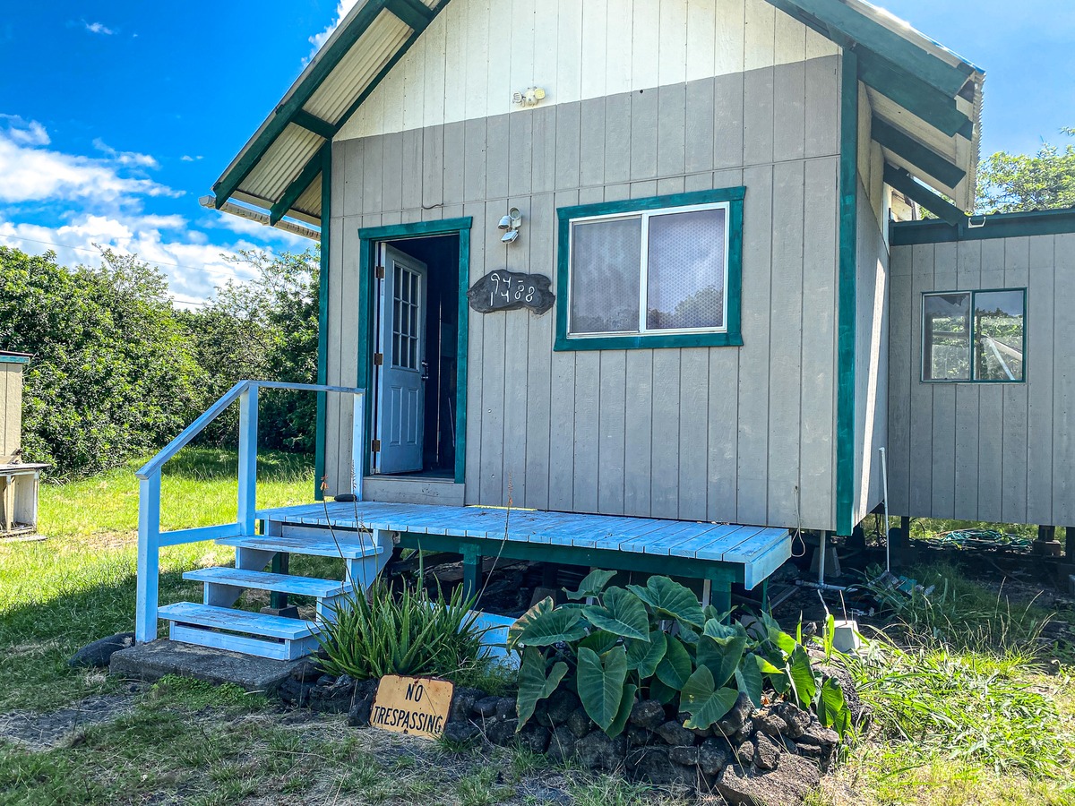 94-1488 Kala Place Naalehu, HI 96772 - Photo 1 of 19 a view of a backyard with plants and a bench