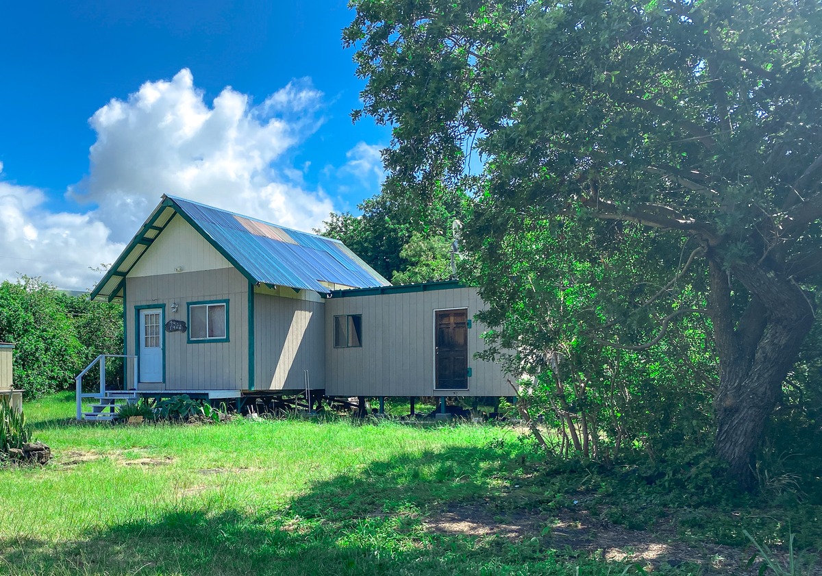 94-1488 Kala Place Naalehu, HI 96772 - Photo 3 of 19 a house with green field in front of it