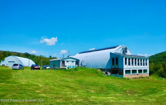 a view of a house with a backyard and porch