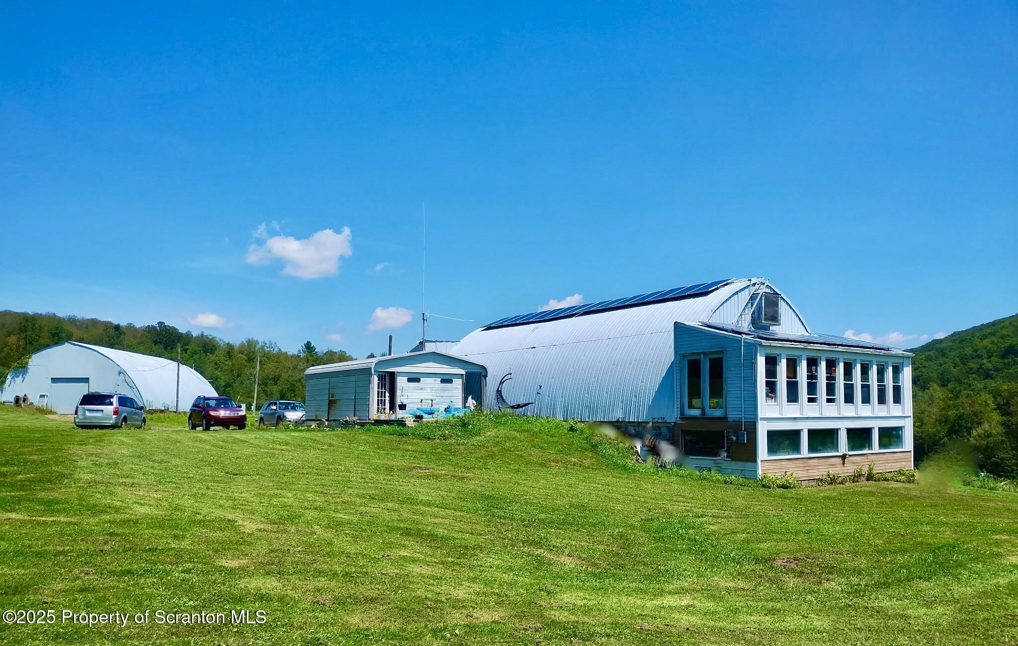a view of a house with a backyard and porch